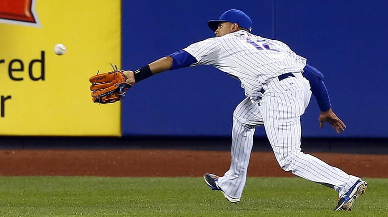 Juan Lagares #12 of the New York Mets makes a...