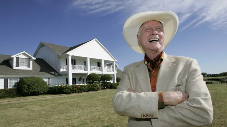Actor Larry Hagman in front of the Southfork Ranch mansion...