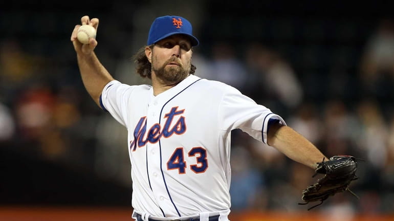 R.A. Dickey delivers a pitch during a game against the...