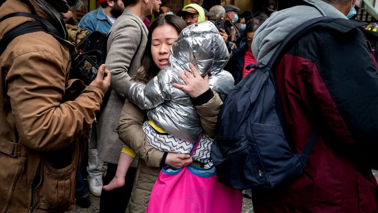 A woman and child after being taken from the burning building.