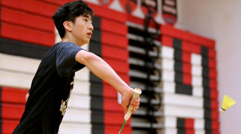 Commack's Andrew Wang returns the back hand volley against Half...