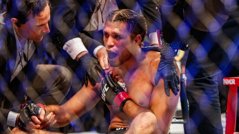 Brian Ortega is injured during his featherweight fight against Yair Rodríguez during...