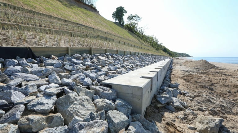 A new sea wall was built at the base of...