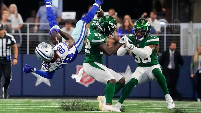 Dallas Cowboys receiver CeeDee Lamb gets upended against Jets defense...