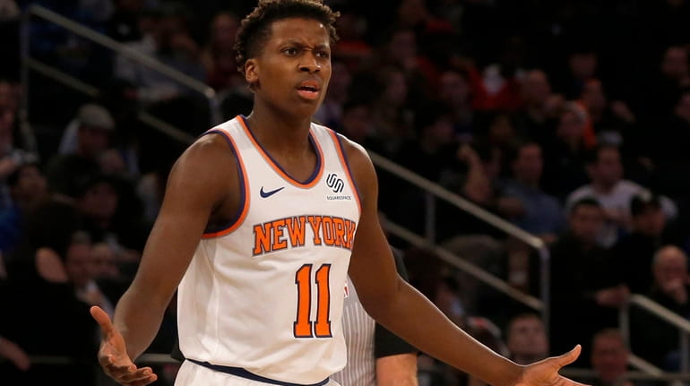Frank Ntilikina #11 of the New York Knicks reacts after...