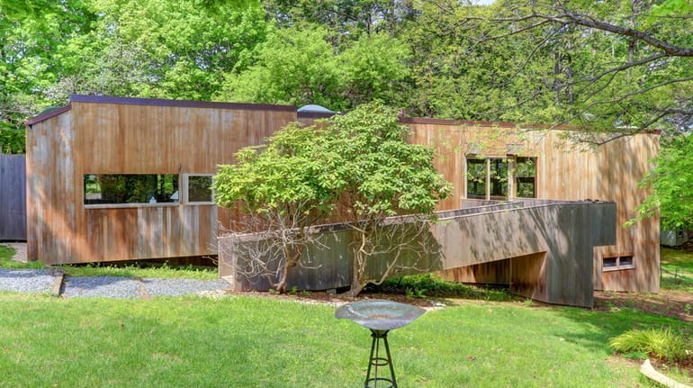 Built in 1971, the Asharoken home features both cedar interiors...
