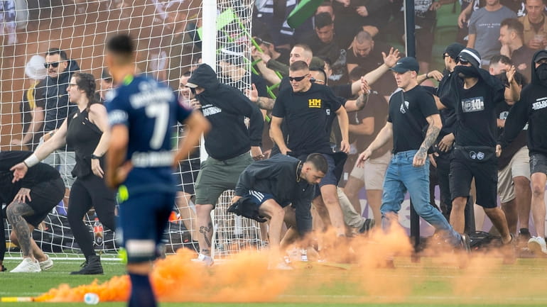 Melbourne Victory fans invade the pitch during the A-League Men's...