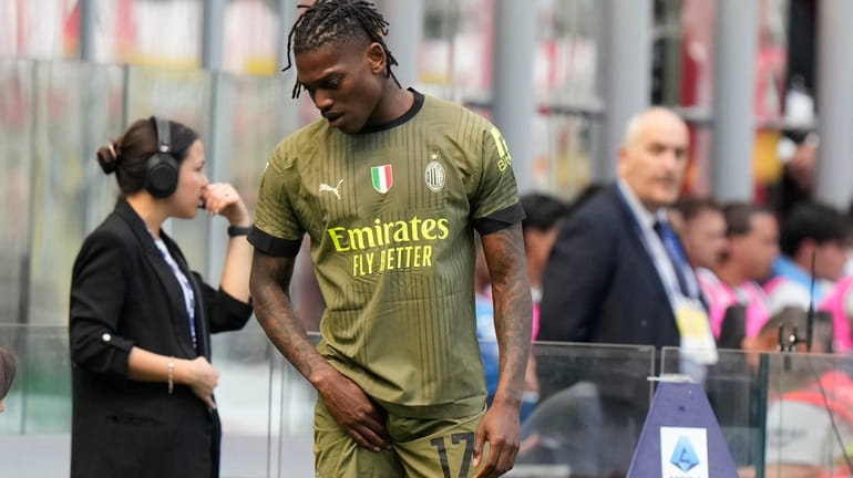 AC Milan's Rafael Leao leaves the pitch after an injury...