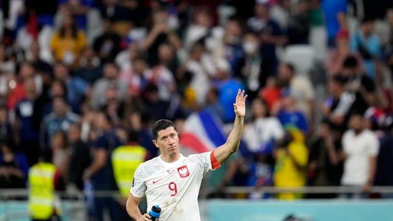 Poland's Robert Lewandowski waves after the World Cup round of...
