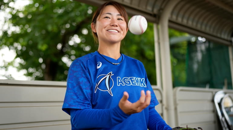 Eri Yoshida of a Japanese women's baseball team, Agekke, smiles...