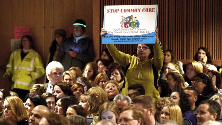People protest at the Common Core Education Forum at Ward...