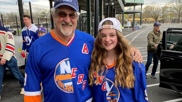 Alain Guillerme and his daughter, Lia, of Manhattan wear half-Islanders,...