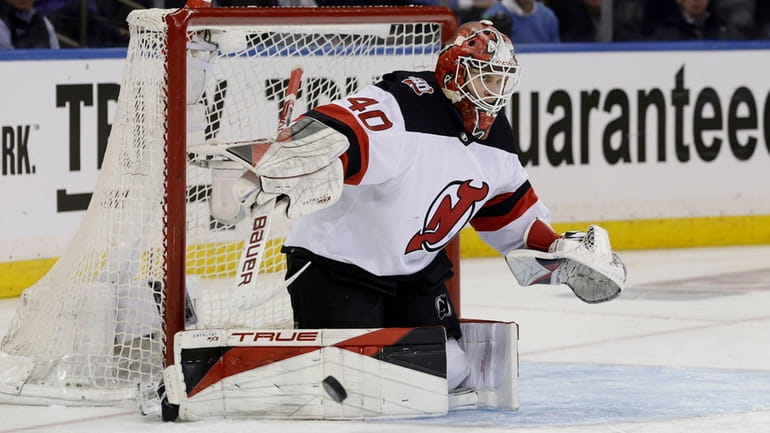Akira Schmid of the Devils makes a save during the third period...
