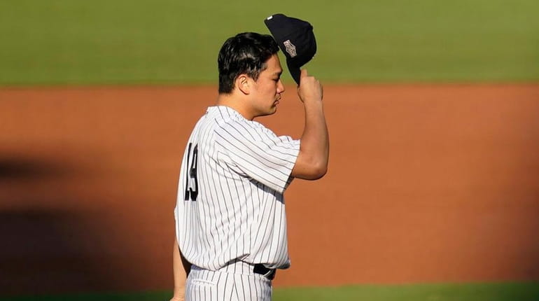 Yankees starting pitcher Masahiro Tanaka prepares during the second inning...