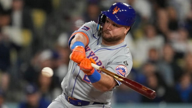Mets designated hitter DJ Stewart hits a sacrifice fly during...