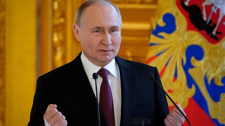 Russia President Vladimir Putin delivers a speech as he meets...