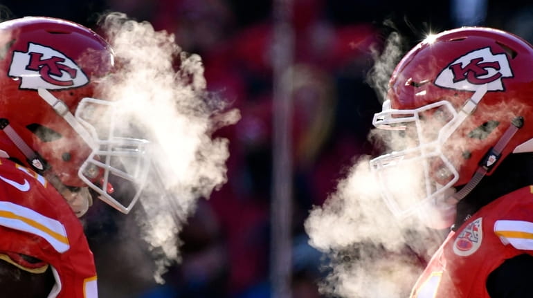 Kansas City Chiefs players' breath masks their faces during a...