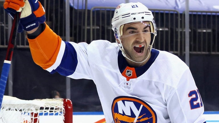 The Islanders' Kyle Palmieri celebrates a power-play goal by Oliver Wahlstrom...