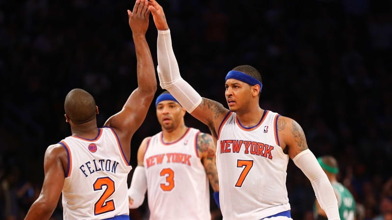 Carmelo Anthony of the Knicks celebrates with Raymond Felton oduring...