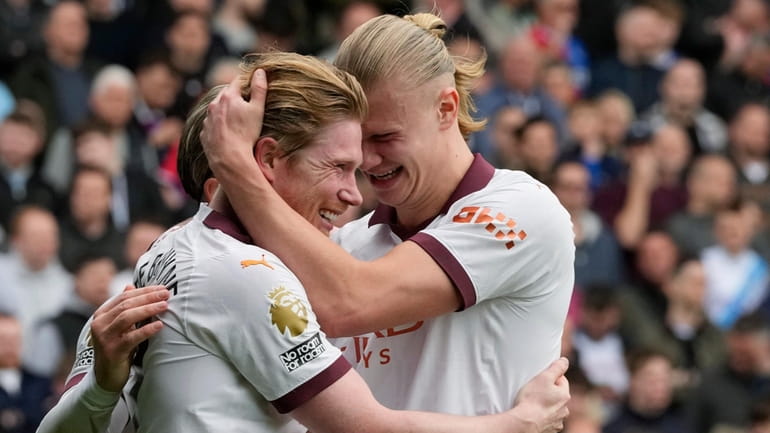 Manchester City's Kevin De Bruyne, centre, celebrates with Jack Grealish,...