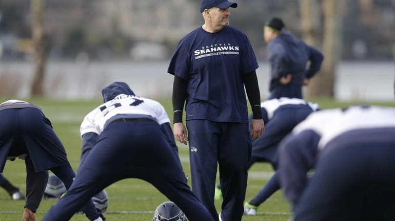 Seahawks defensive coordinator Dan Quinn walks on the field as...