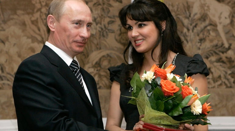 Russian President Vladimir Putin congratulates Russian opera singer Anna Netrebko...