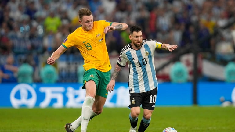Australia's Harry Souttar chases Argentina's Lionel Messi during the World...