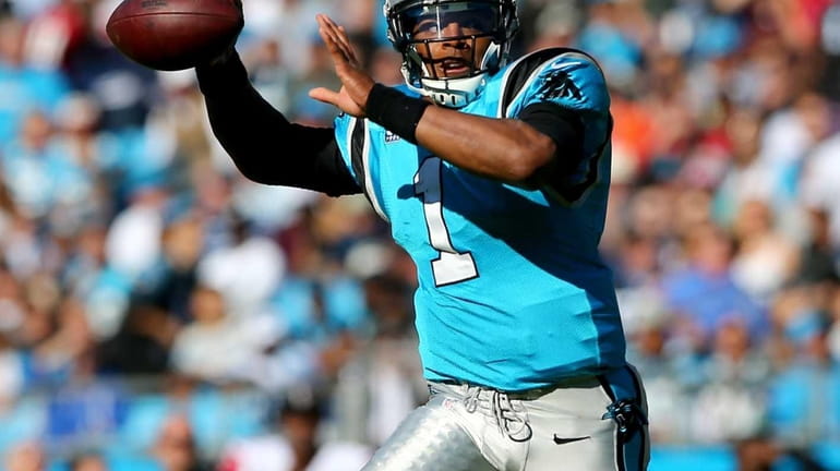 Carolina Panthers quarterback Cam Newton looks to pass during a...