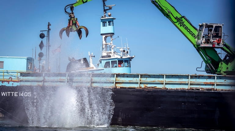 Recycled construction material is dropped into the Long Island Sound in...