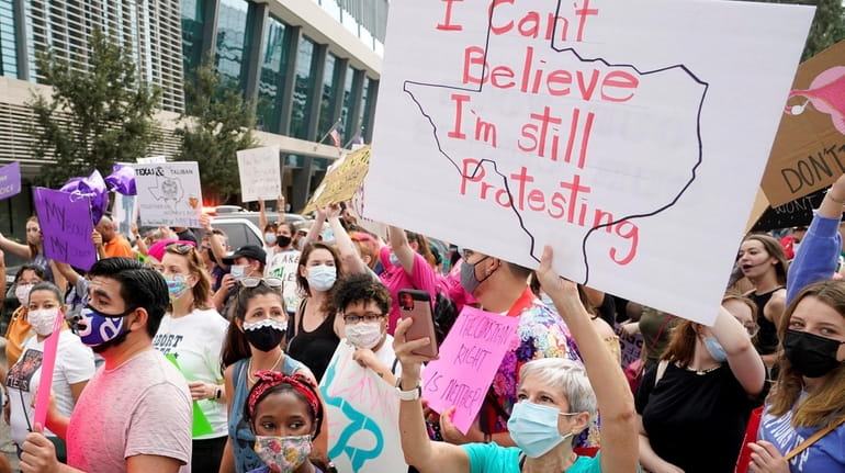 Demonstrators protest the Texas abortion ban during the Houston Women's March...
