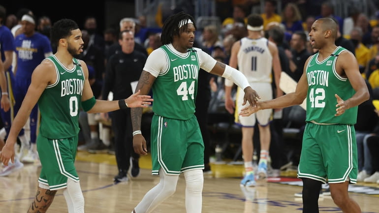 Celtics forward Jayson Tatum (0) celebrates with center Robert Williams...