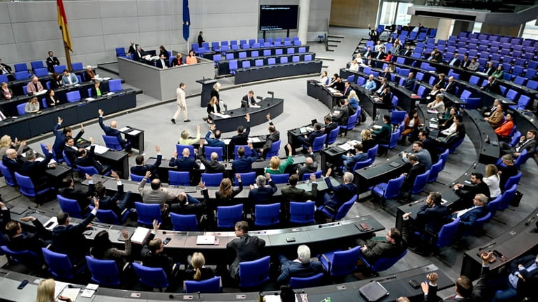 MPs vote during the 164th session of the Bundestag, the...