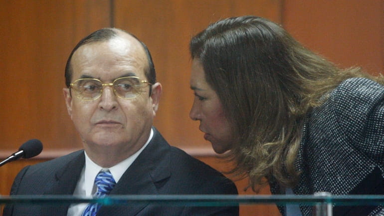 Vladimiro Montesinos, left, listens to his lawyer Estela Valdivia as...