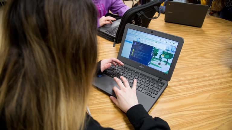 Students use Chromebooks in teacher Erica Giordano's seventh-grade coding class...