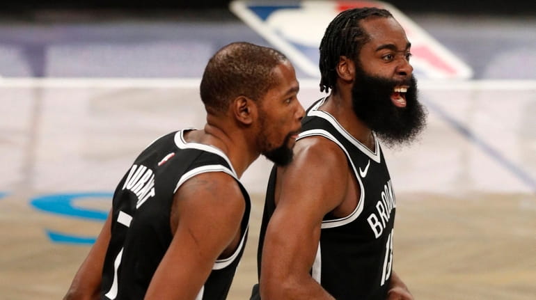 James Harden and Kevin Durant of the Nets react during...