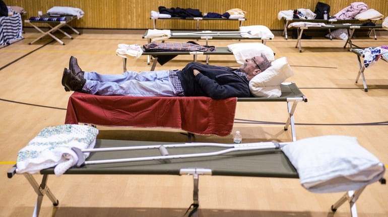 Jimmy Comuniello sleeps on his cot inside Ascension Lutheran Church...