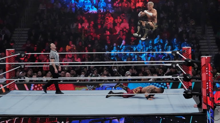 Wrestler Akira Tozawa goes airborne during his match with Carmelo...