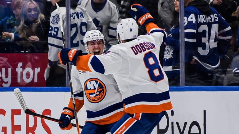 Islanders defenceman Noah Dobson and left wing Anthony Beauvillier celebrate after Beauvillier...
