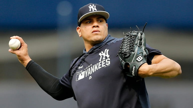 Dellin Betances of the Yankees warms up on the field before...