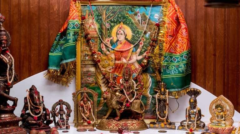 Tejas Nanavati's sacred space in Huntington Station includes statues and idols...