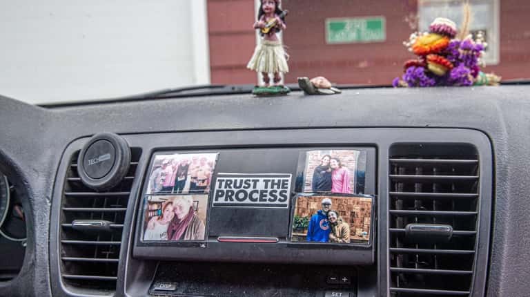 Mary Latham calls the photos on her dashboard her guardian...