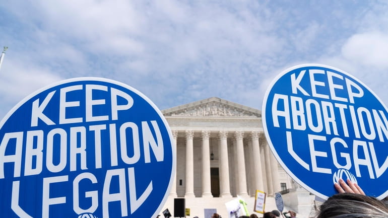 Demonstrators protest outside of the Supreme Court Tuesday, May 3,...