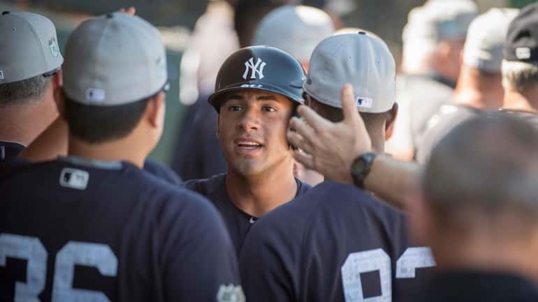 New York Yankees' Gleyber Torres is greeted with high fives...