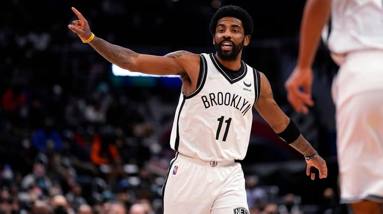 Brooklyn Nets guard Kyrie Irving shouts instructions to teammates during...