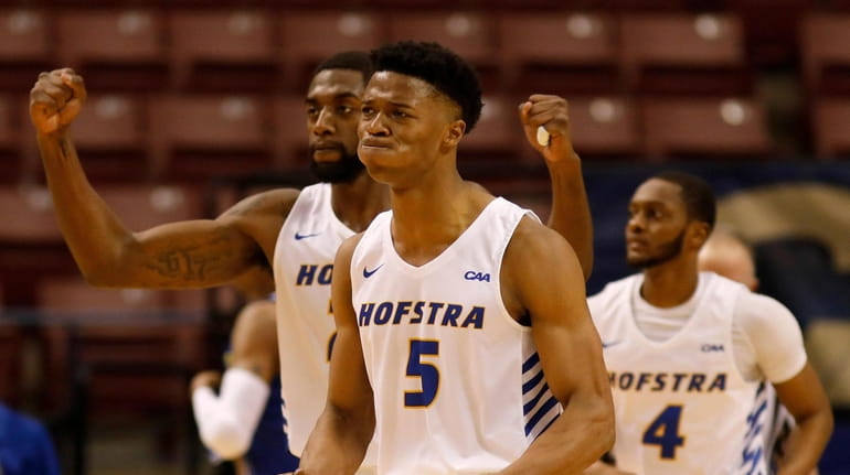 Hofstra's Eli Pemberton (5) celebrates with Jacquil Taylor, left, and...