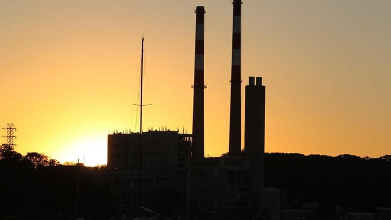 LIPA power plants towers are seen at sunset over Port...