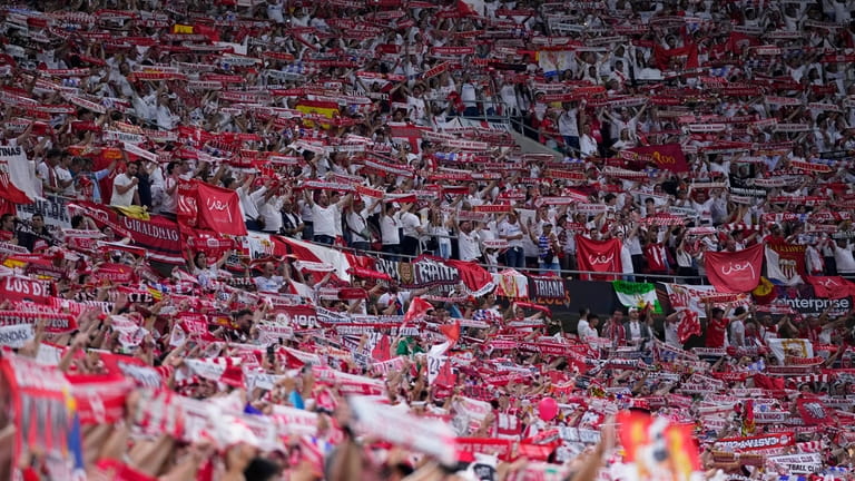 Sevilla fans hold up their scarves during the Europa League...