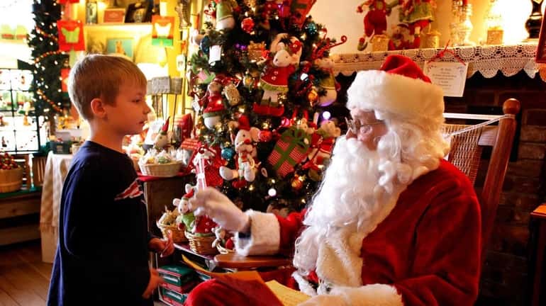 Drew Wimmer, 6, of Huntington, gives Santa his holiday wish...
