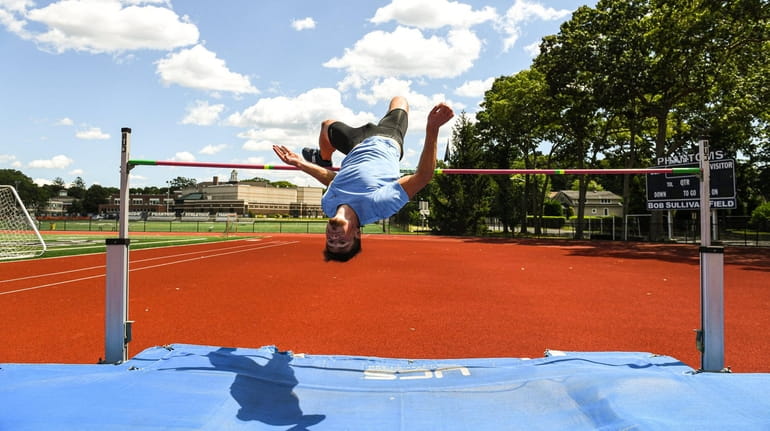 Jack Flood practices the high jump while training for the...