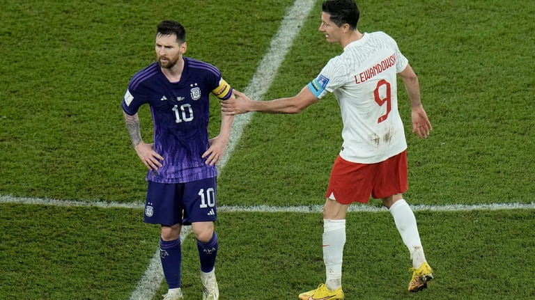 Poland's Robert Lewandowski, right, interacts with Argentina's Lionel Messi at...
